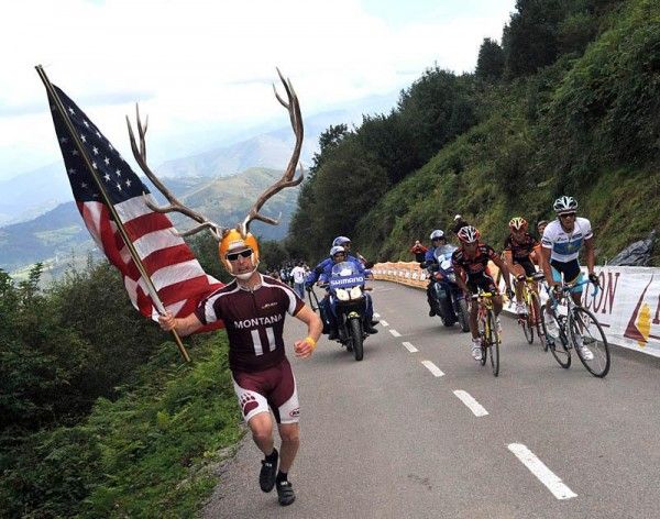 An American fan runs ahead of Contador's group.