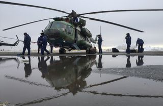 Russian MI-8 helicopter personnel secure their helicopter after arriving at Zhezkazgan Airport in Kazakhstan Tuesday, March 1, 2016, ahead of the Soyuz TMA-18M spacecraft landing with Expedition 46 Commander Scott Kelly of NASA and Russian cosmonauts Mikh