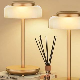 Two gold cordless table lamps