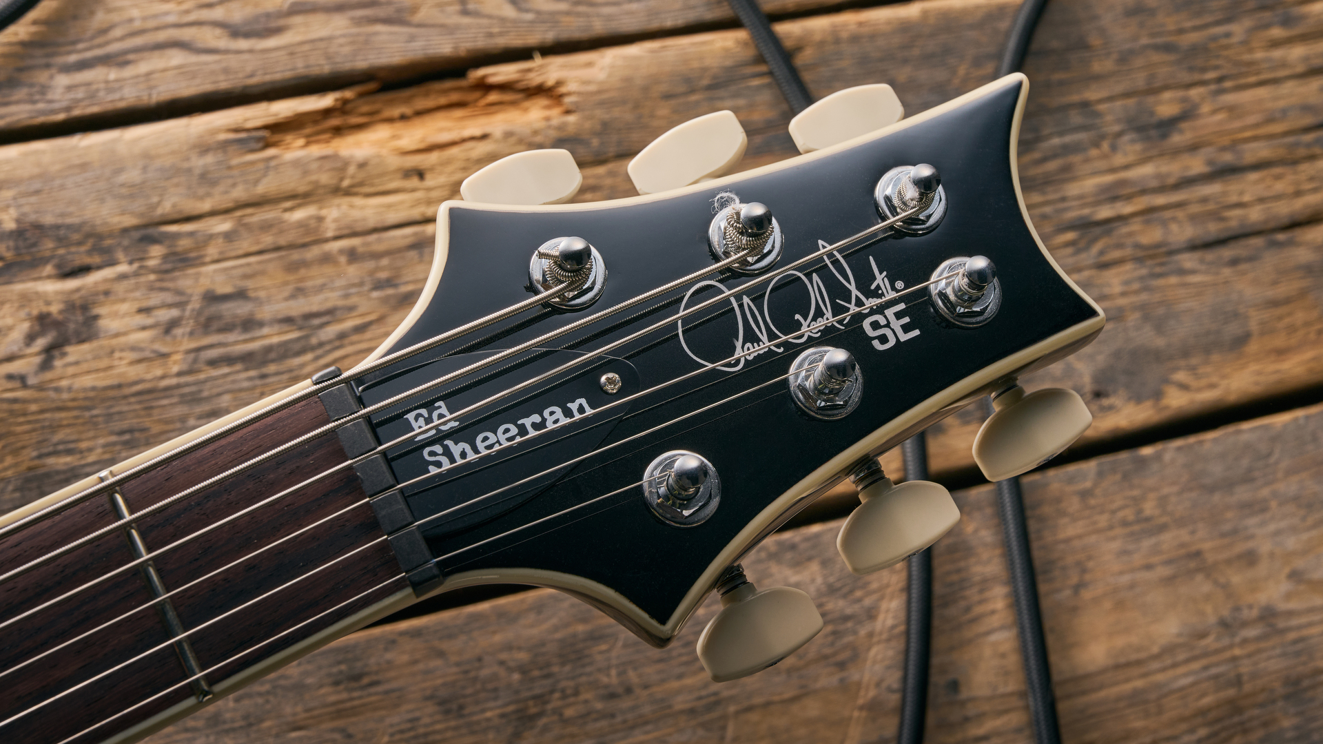 close up of⁤ the ⁢headstock of the PRS SE Ed‌ Sheeran Hollowbody​ I Piezo Baritone guitar