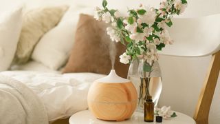 Diffuser on a bedside table within a calm bedroom setting