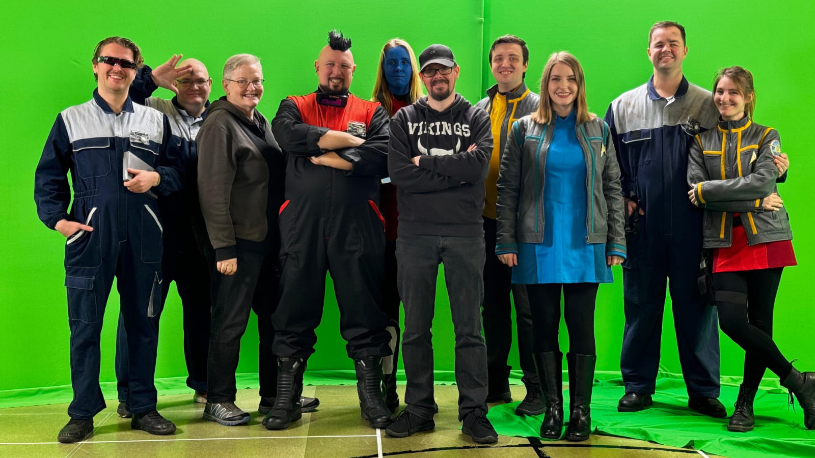 Actors in a Star Trek film stand in front of a green screen