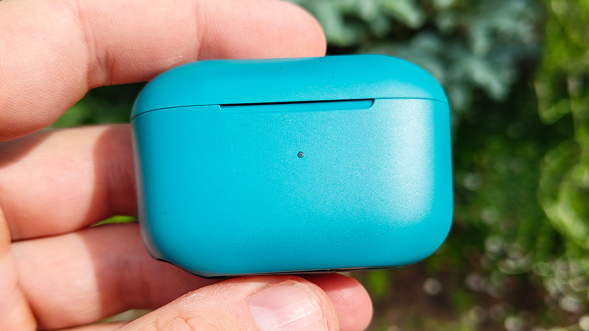 JLab Go Pop+ in-ear headphones charging case held in hand