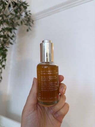 Mica Ricketts holding Beauty Pie YouthBomb 360° Radiance Concentrate Serum