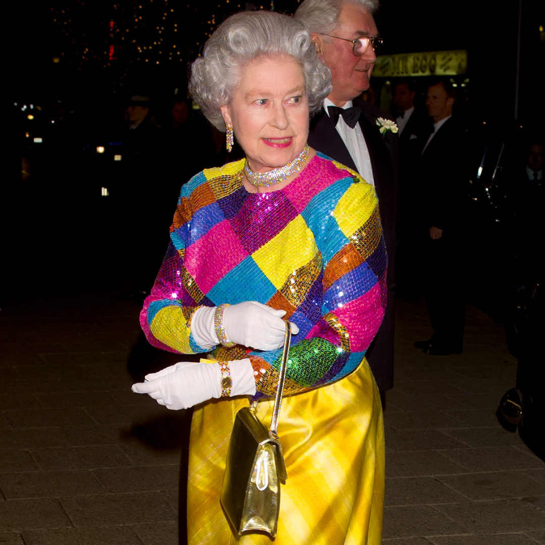 Queen Elizabeth wearing a colorful sequined gown and smiling 