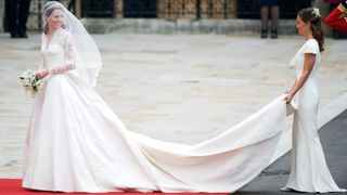 The Princess of Wales on her wedding day with her veil held by Pippa Middleton