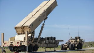 a large missile launcher on the back of a military truck