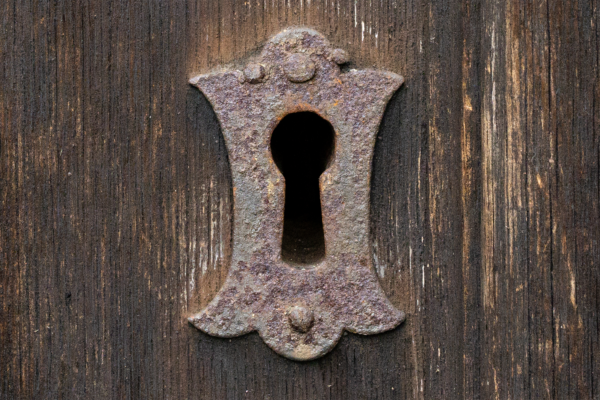 Close up of rusted lock on wooden door at ISO 6400
