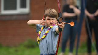 Britain's Prince Louis of Wales tries his hand at archery while taking part in the Big Help Out, during a visit to the 3rd Upton Scouts Hut in Slough on May 8, 2023 in London, England