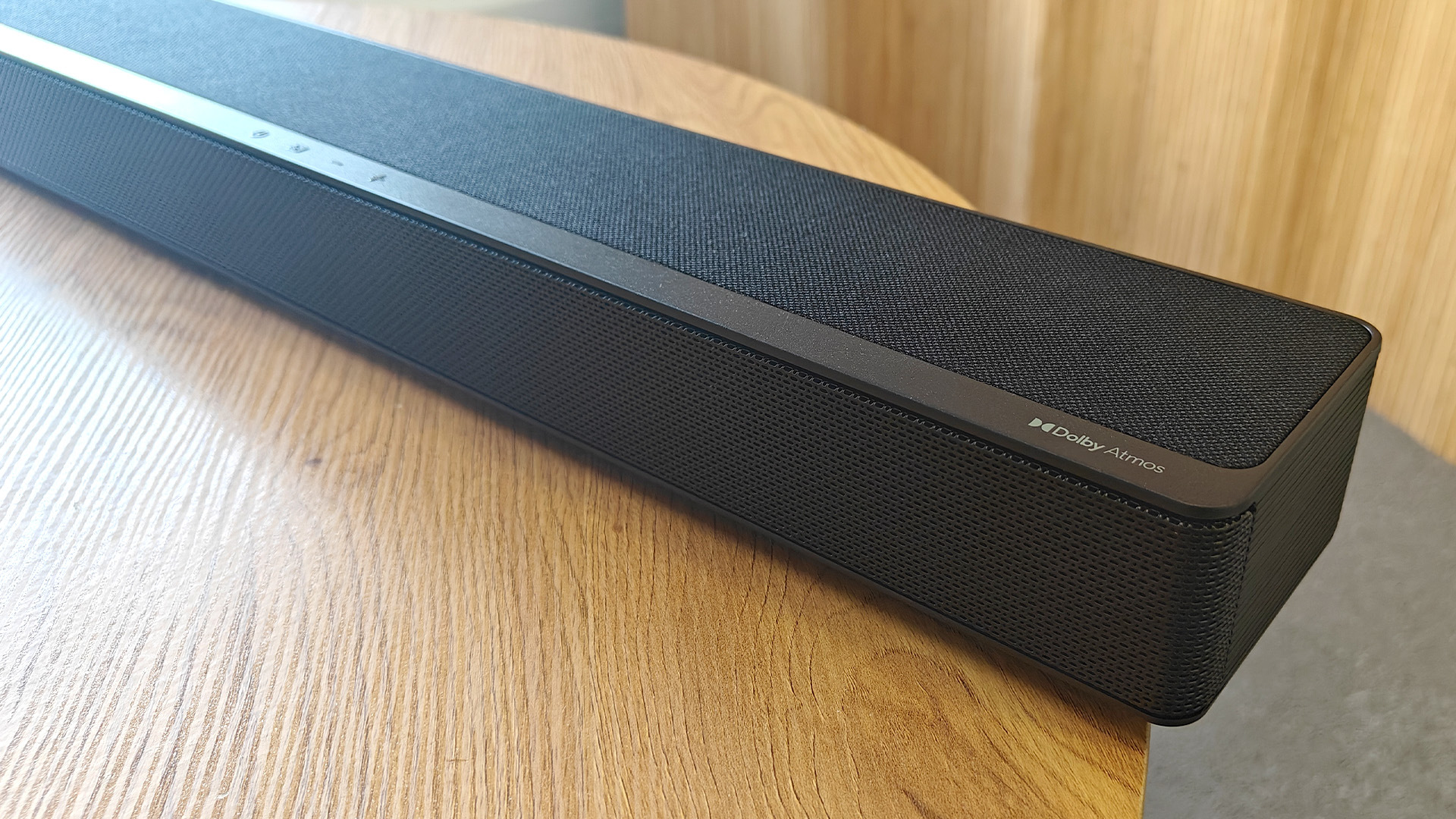 The Hisense AX5125H Dolby Atmos soundbar system, pictured on a round, wooden table