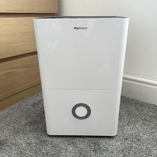 The Pro Breeze 30L High Capacity Smart Dehumidifier review being tested in a room with grey carpet