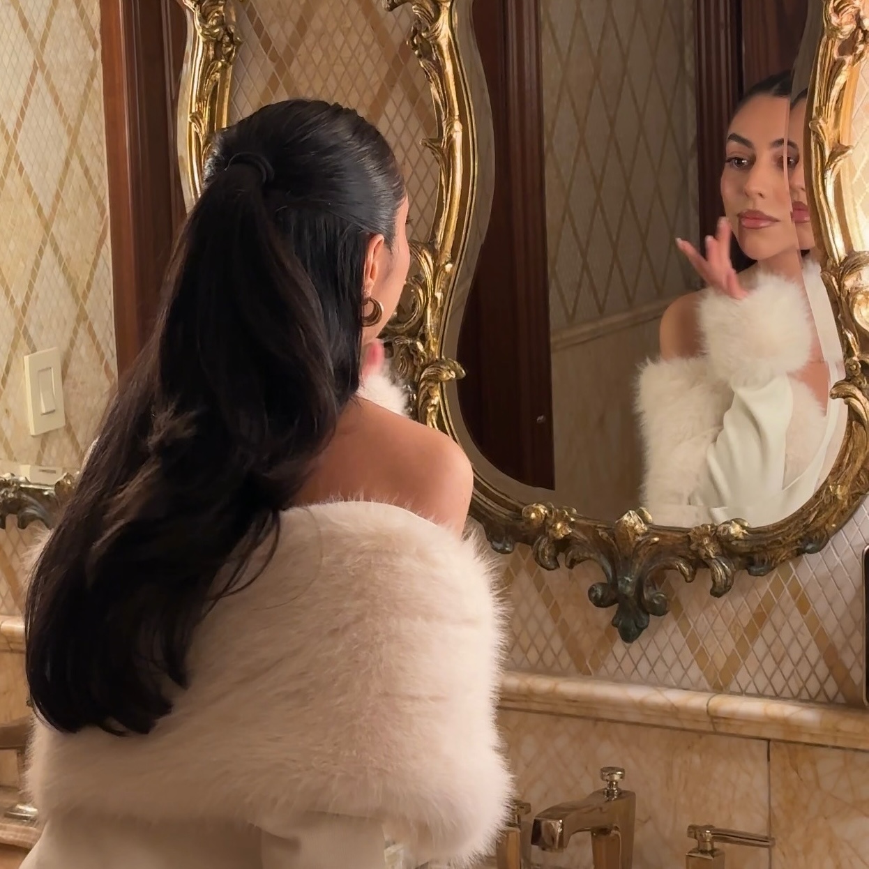 Woman touching up her makeup in a mirror