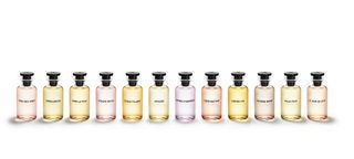 collection of pastel coloured Louis Vuitton fragrance bottles against white background