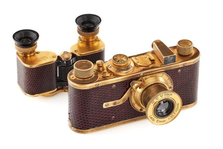 A gold and brown Leica camera