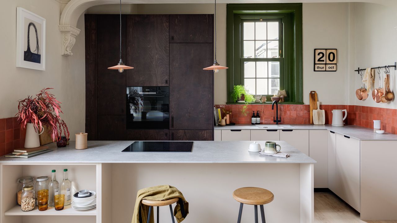 Slab kitchen with two tone black and white cupboards and island