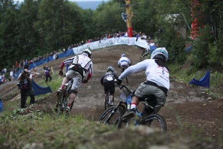 Racers zoom down the four cross course.