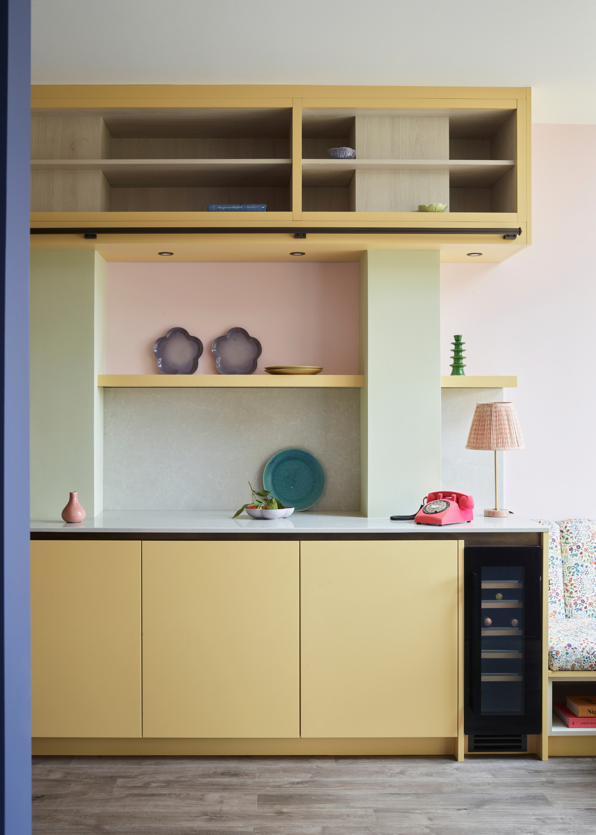 a pastel yellow kitchen in a sleek design with plenty of pastel tones used throughout