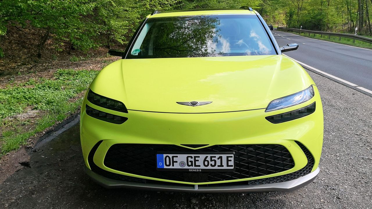 Front view of green GV60 parked at side of road