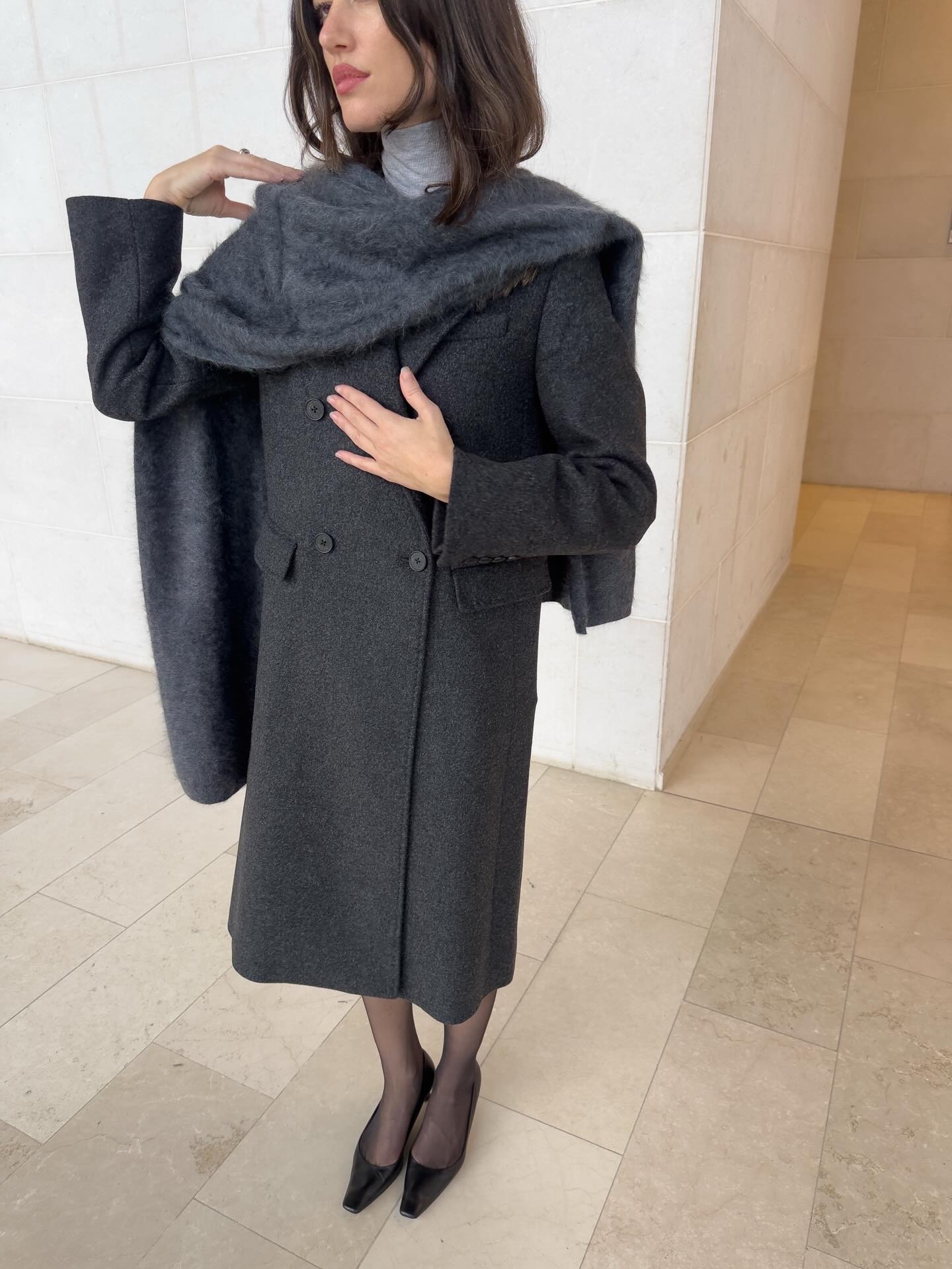 Woman in long elegant gray coat.