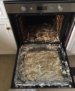 oven being cleaned with baking soda, dish soap and water paste, the TikTok oven cleaning hack