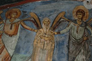Depiction of St. Neophytos flaked by the archangels Michael and Gabriel, who hold him by the shoulders (Bema), in a painting in the Byzantine monastery Enkleistra of St. Neophytos in Cyprus.