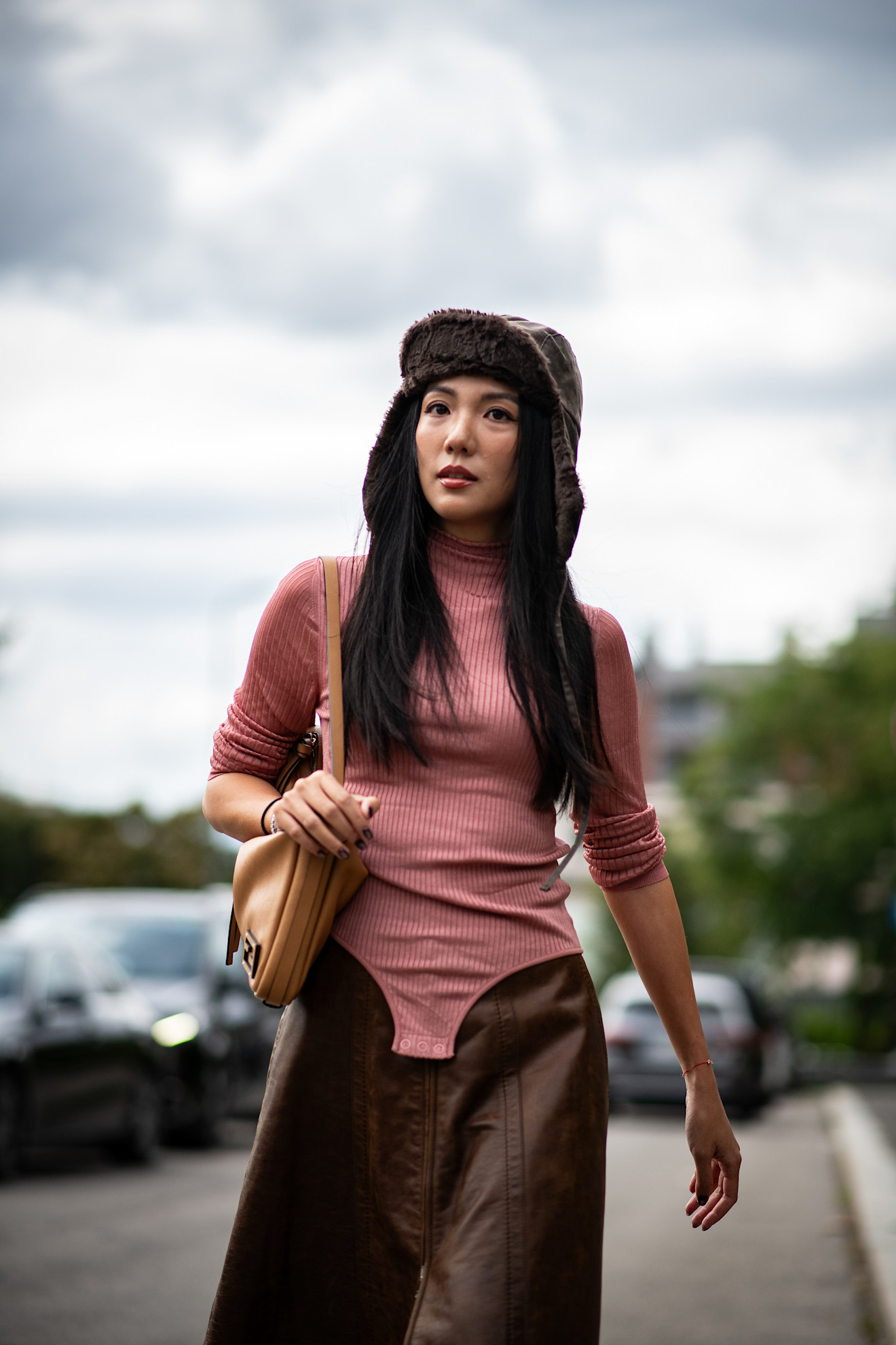 Fur accessory trend is shown in a street style photo of a woman