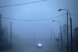 A lone police car on patrol during the passing of Hurricane Irma in Fajardo, Puerto Rico. The Category 5 storm skirted Puerto Rico on Sept. 6, packing winds of more than 180 mph (290 km/h).