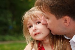 Father consoling his daughter.