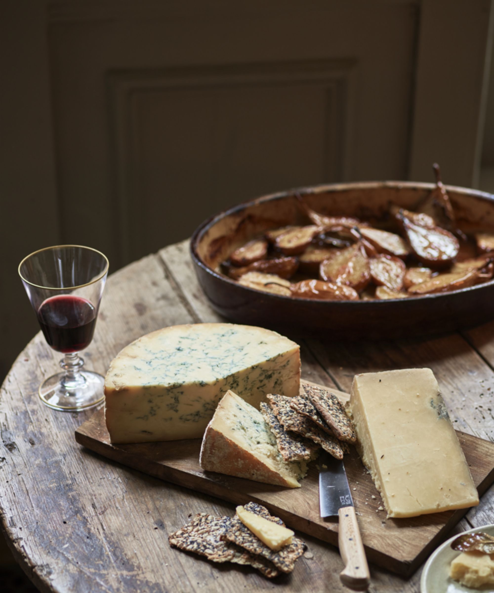Cheese and biscuits on a rustic wooden table
