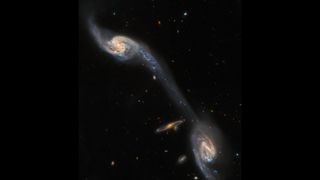 A Hubble Space Telescope image of two galaxies joined by a tidal tail.