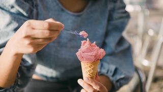Woman eating pink icecream