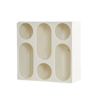 A white bookshelf with curved-shaped cubbies