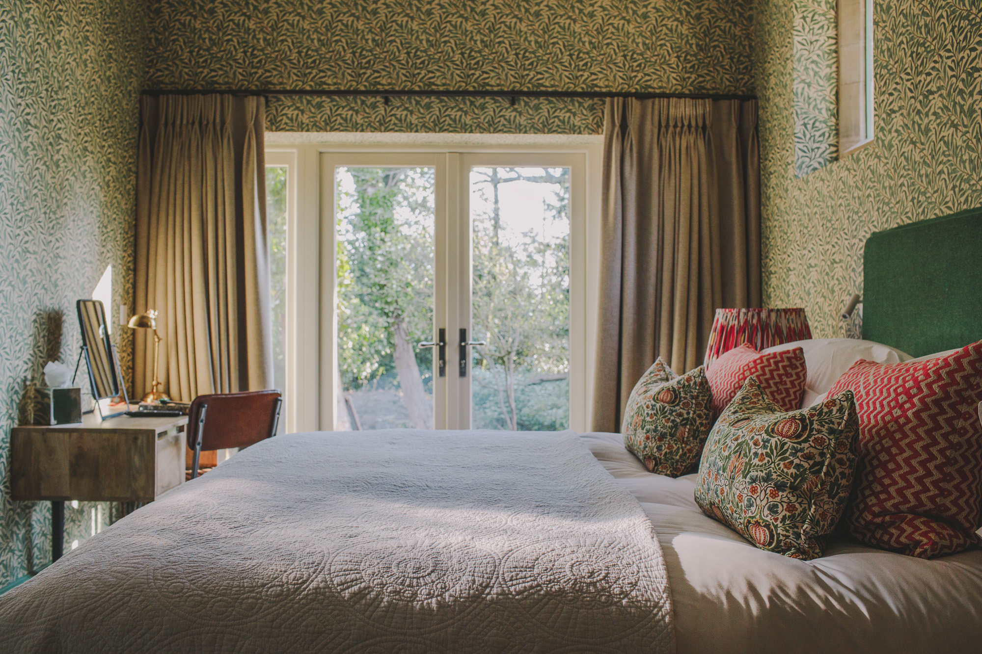 A William Morris-inspired, crafty hotel features rooms plastered in floral wallpapers, organic sculptures, and vibrant textiles.