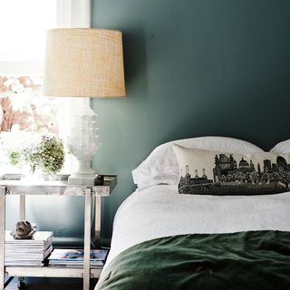 bedroom with dark green room and bed