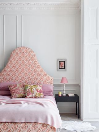 bed with shaped upholstered headboard