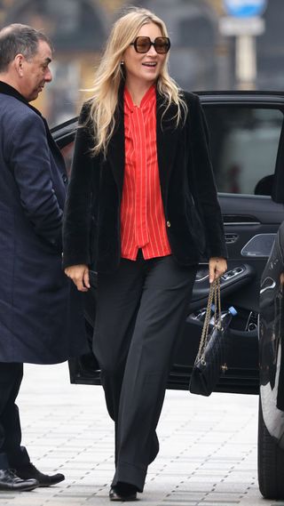 Kate Moss wearing red shirt, velvet blazer and suit trousers