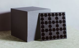 patterned with inverted pentagons in glossy foil on a matte black foam board