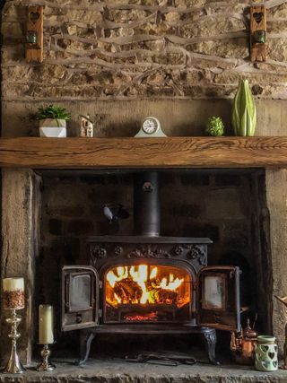 black log burner in cottage fireplace