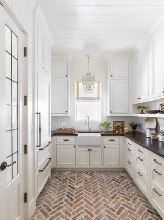 antique brick flooring in white pantry by Marie Flanigan Interiors