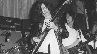 Rodgers plays a Gibson Flying V as he and Tetsu Yamauchi perform at a 1972 Free concert in the U.K