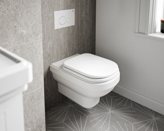 A wall hung toilet in a bathroom with modern grey tiles