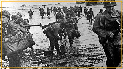 A black and white photo of soldiers in World War II uniforms walking up a beach. 
