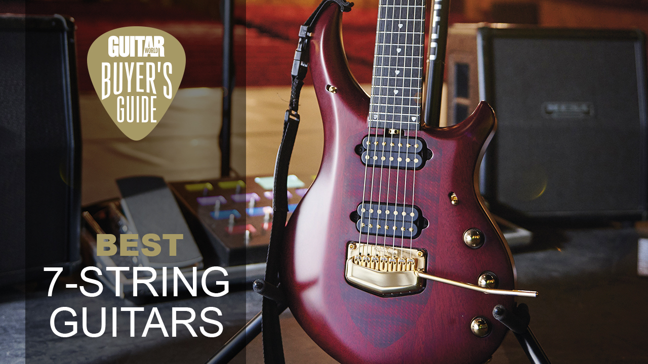 An Ernie Ball Music Man John Petrucci Majesty 7-string guitar on stage with various bits of music gear