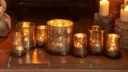 A mantelpiece with a display of candles