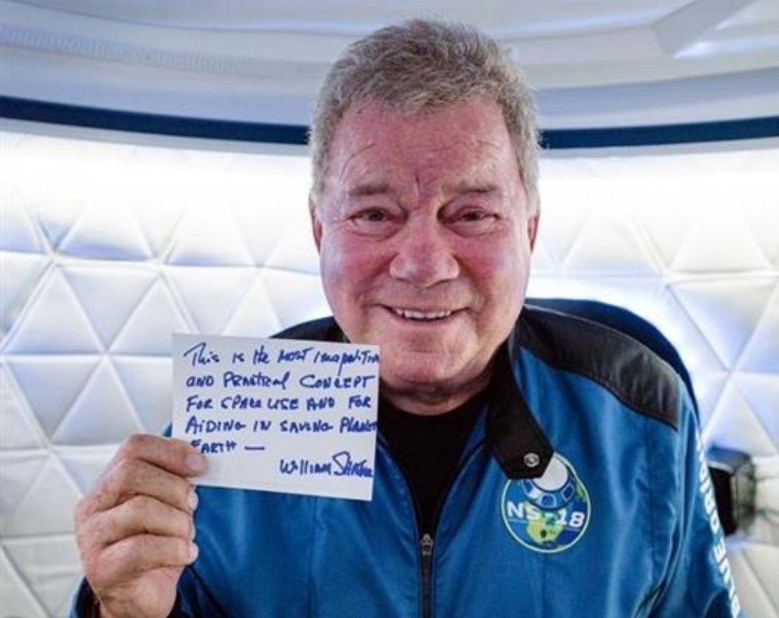 Actor William Shatner holds up a postcard he wrote for Blue Origin's Club For The Future that will fly in space on his New Shepard rocket.