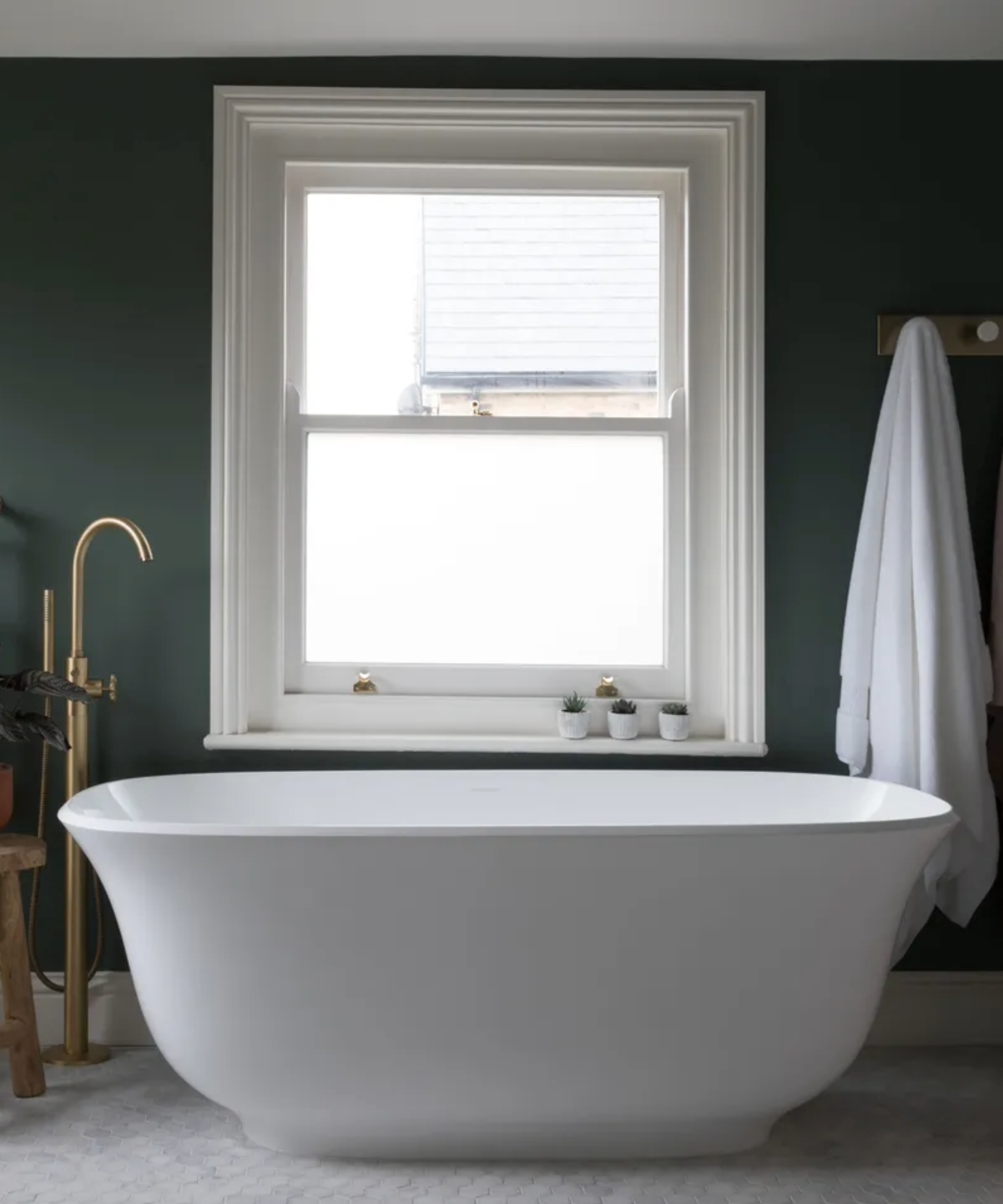 a bathroom with window film on a sash window