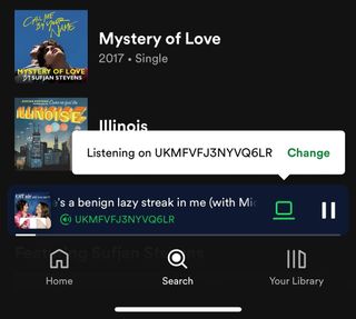 Spotify user interface showing that a podcast is playing on a laptop