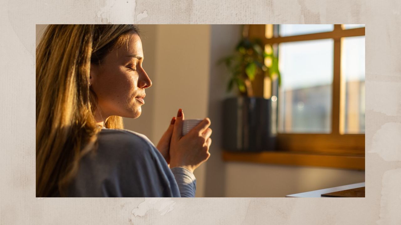 Woman drinking coffee at home at sunrise