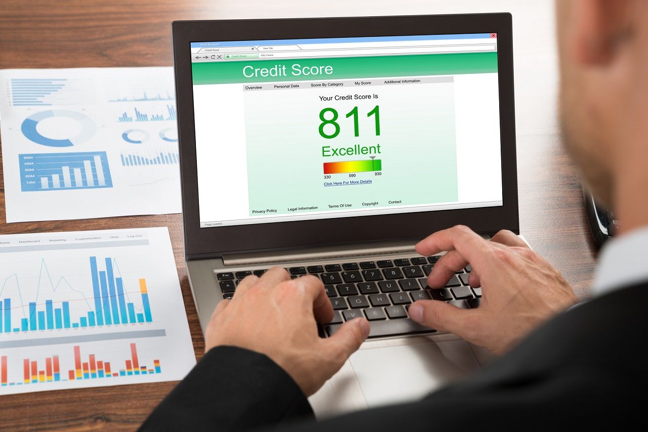 Close-up Of A Businessman Checking Credit Score Online On Laptop