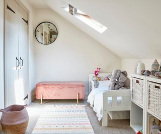 child's loft bedroom with white floors, walls, furniture and pink accessories